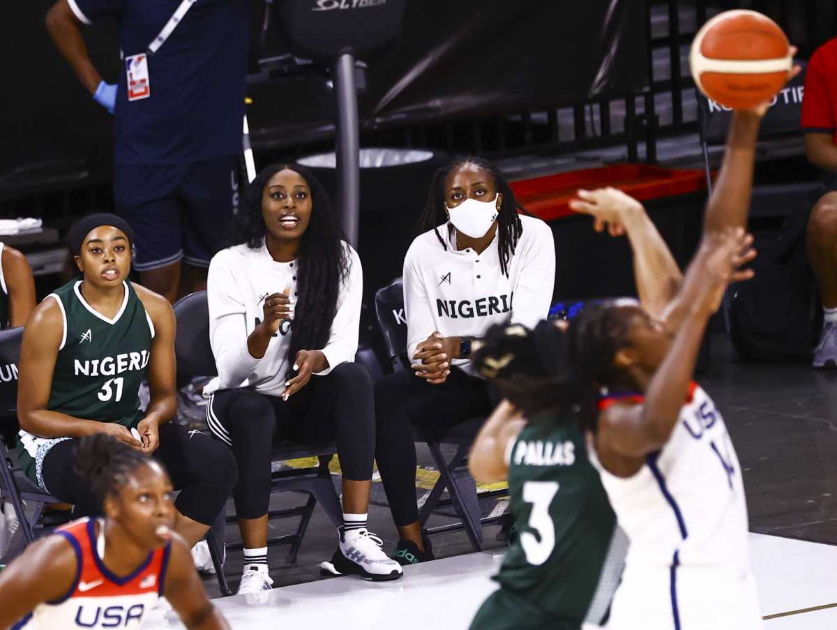 In a photo taken on July 18, 2021, Nigerian guard Erica Erinma Ogwumike (31) watches the game alongside her sisters Chiney Ogwumike and Nneka Ogwumike in the women's basketball and exhibition match between Nigeria and the United States, in Las Vegas. (Chase Stevens / Las Vegas Review-Journal via AP)