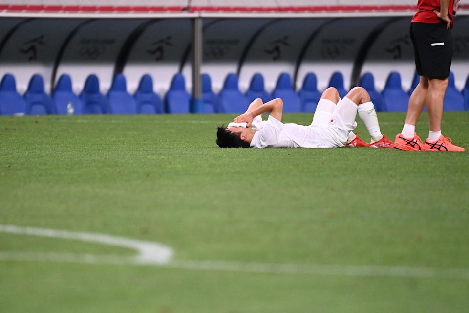 Japan & # 39; s forward Takefusa Kubo cries following their defeat in the Tokyo 2020 Olympic Games men & # 39; s bronze medal football match between Mexico and Japan at Saitama Stadium in Saitama on August 6, 2021. (Photo by Jonathan NACKSTRAND / AFP) (Photo by JONATHAN NACKSTRAND / AFP via Getty Images)