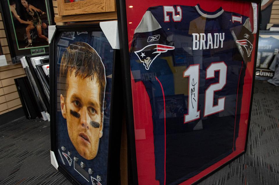 Tom Brady posters decorate the Sportsworld sports memorabilia store in Saugus, Mass., on Feb. 1, 2022. (Photo: JOSEPH PREZIOSO/AFP via Getty Images)