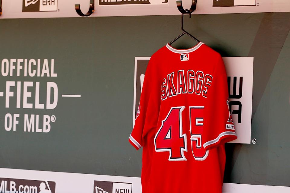 OAKLAND, CALIFORNIA - The jersey of the recently deceased Los Angeles Angels pitcher Tyler Skaggs hangs in the team dugout before the Los Angeles Angels game against the Oakland Athletics on September 5, 2019 in Oakland, California.  (Photo by Lachlan Cunningham/Getty Images)