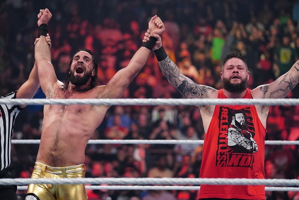 Kevin Owens and Seth Rollins celebrating a victory on WWE Raw