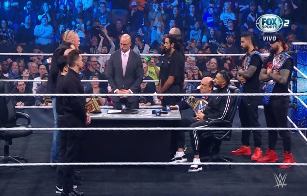 Roman Reigns and Brock Lesnar sign the contract for their