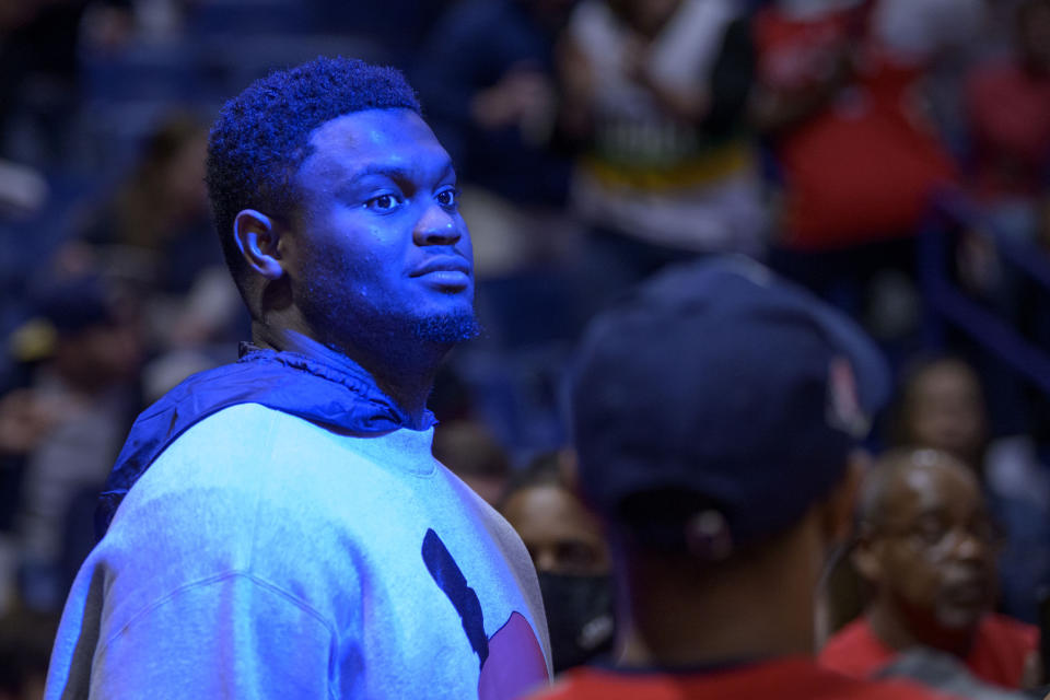 New Orleans Pelicans forward Zion Williamson, who isá  inactive, watches introductions before the NBA game against the Phoenix Suns in New Orleans, Tuesday, March 15, 2022. (AP Photo/Matthew Hinton)