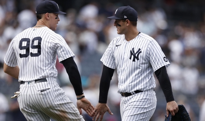 Two Yankees players between brands of Venezuelans on Opening Day