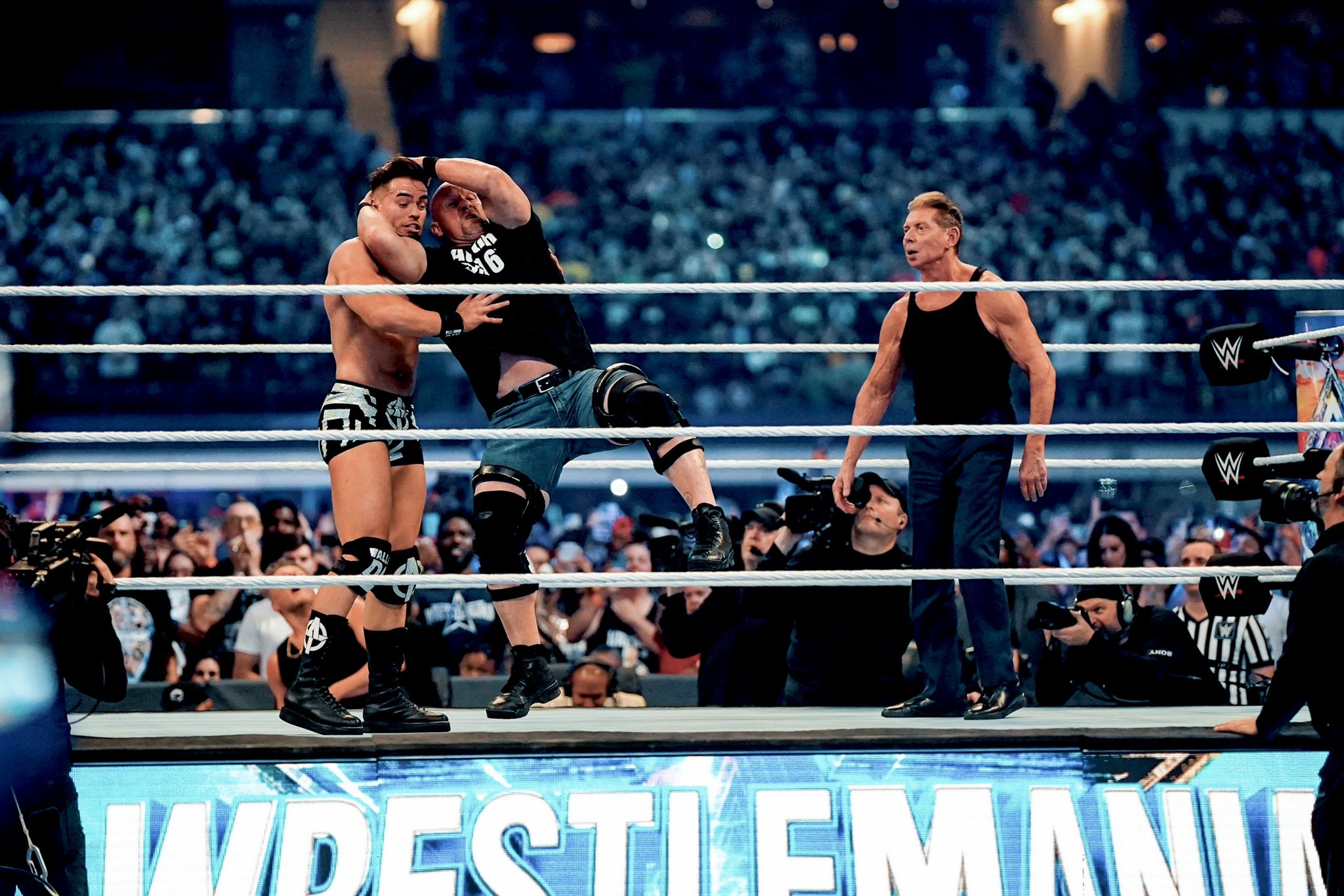 Steve Austin applies the Stunner to Austin Theory against Vince McMahon at WrestleMania 38