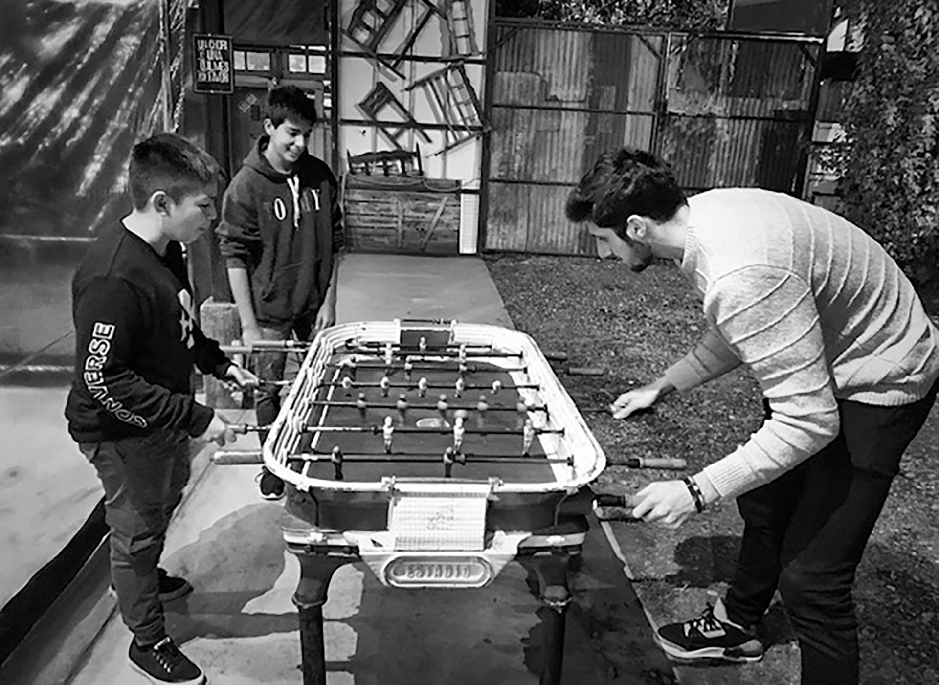 Bolmaro playing foosball with the children of the guests