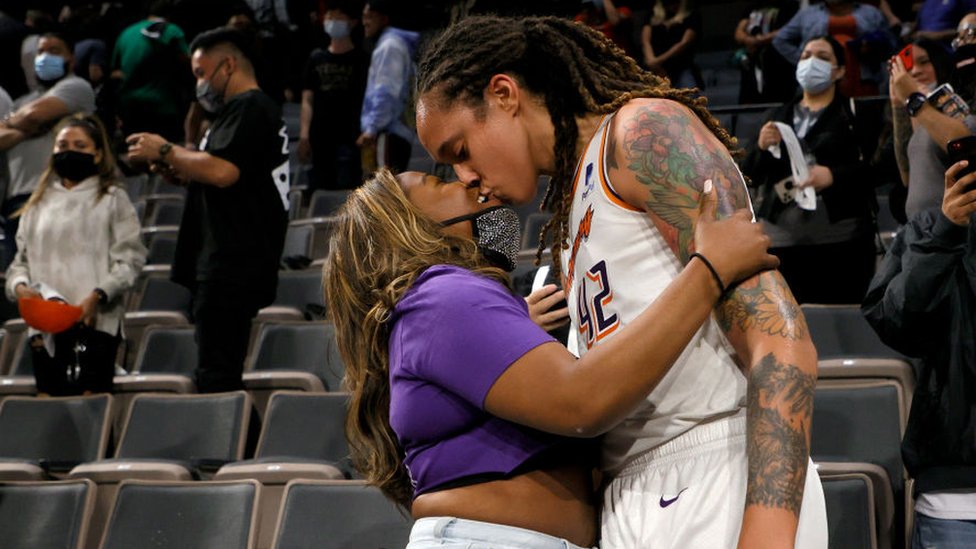 Brittney Griner #42 of the Phoenix Mercury team kisses her wife Cherelle Griner after winning a match