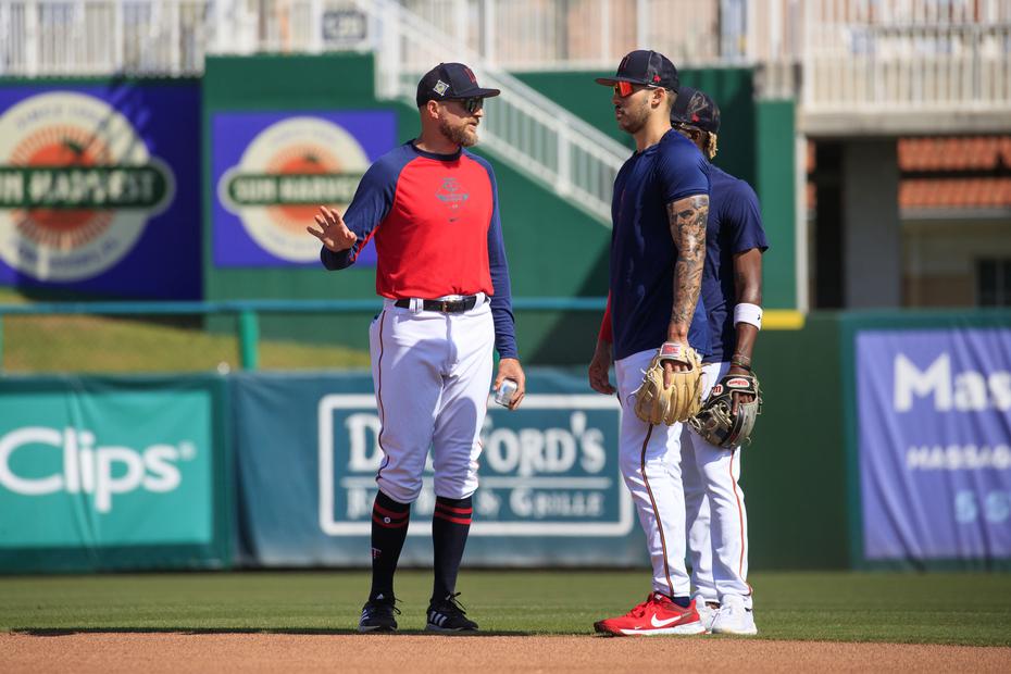 Carlos Correa listens to Twins manager Rocco Baldelli during practice in Fort Myers. 