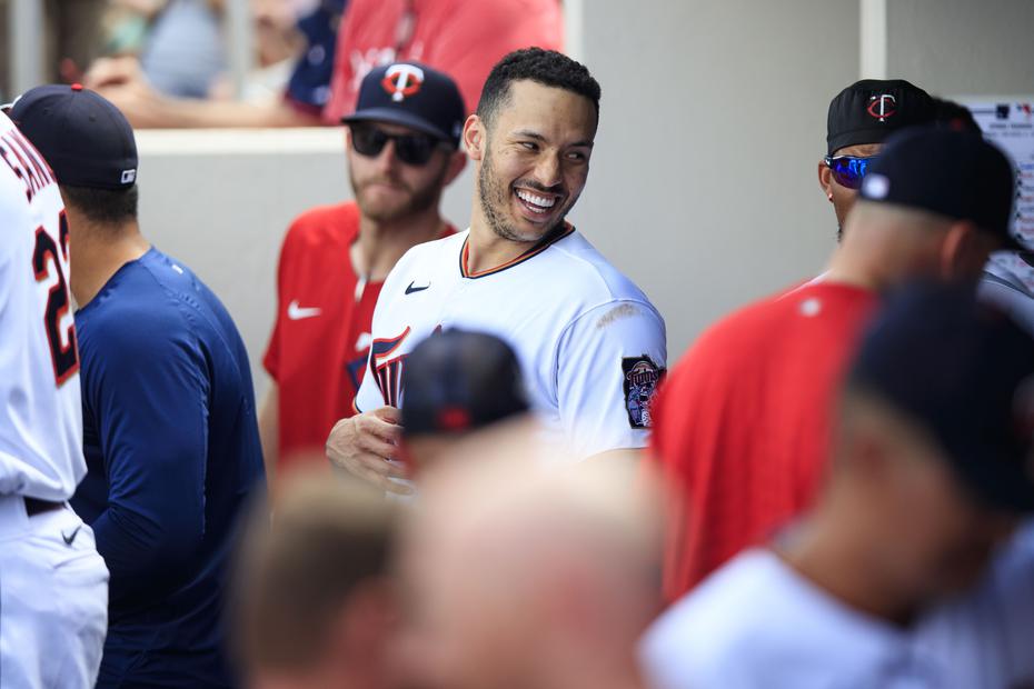 Carlos Correa smiles as he chats with his teammates in the Twins' dugout during the game against Pittsburgh on March 30. 