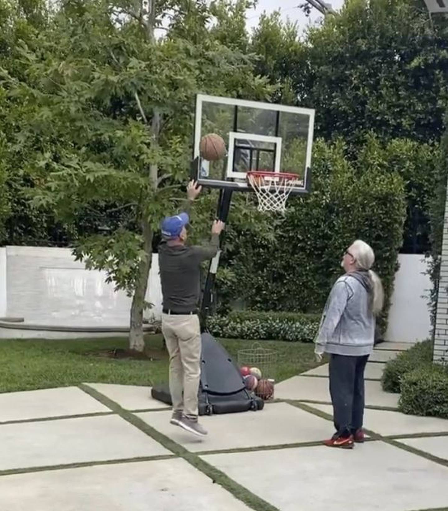 Happy and fit Bruce Willis appears playing a basketball challenge