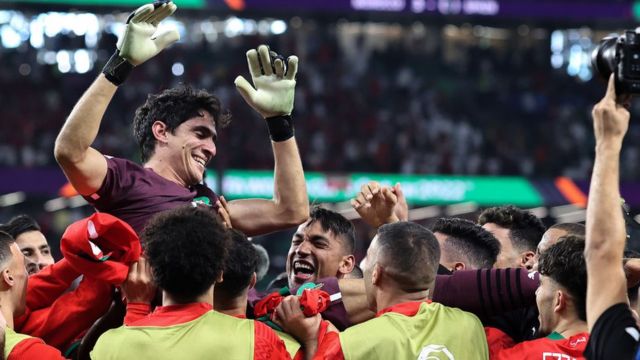 Moroccan goalkeeper Yassine Bounou is thrown into the air as Morocco celebrates their victory during the FIFA World Cup Qatar 2022 round of 16 match between Morocco and Spain