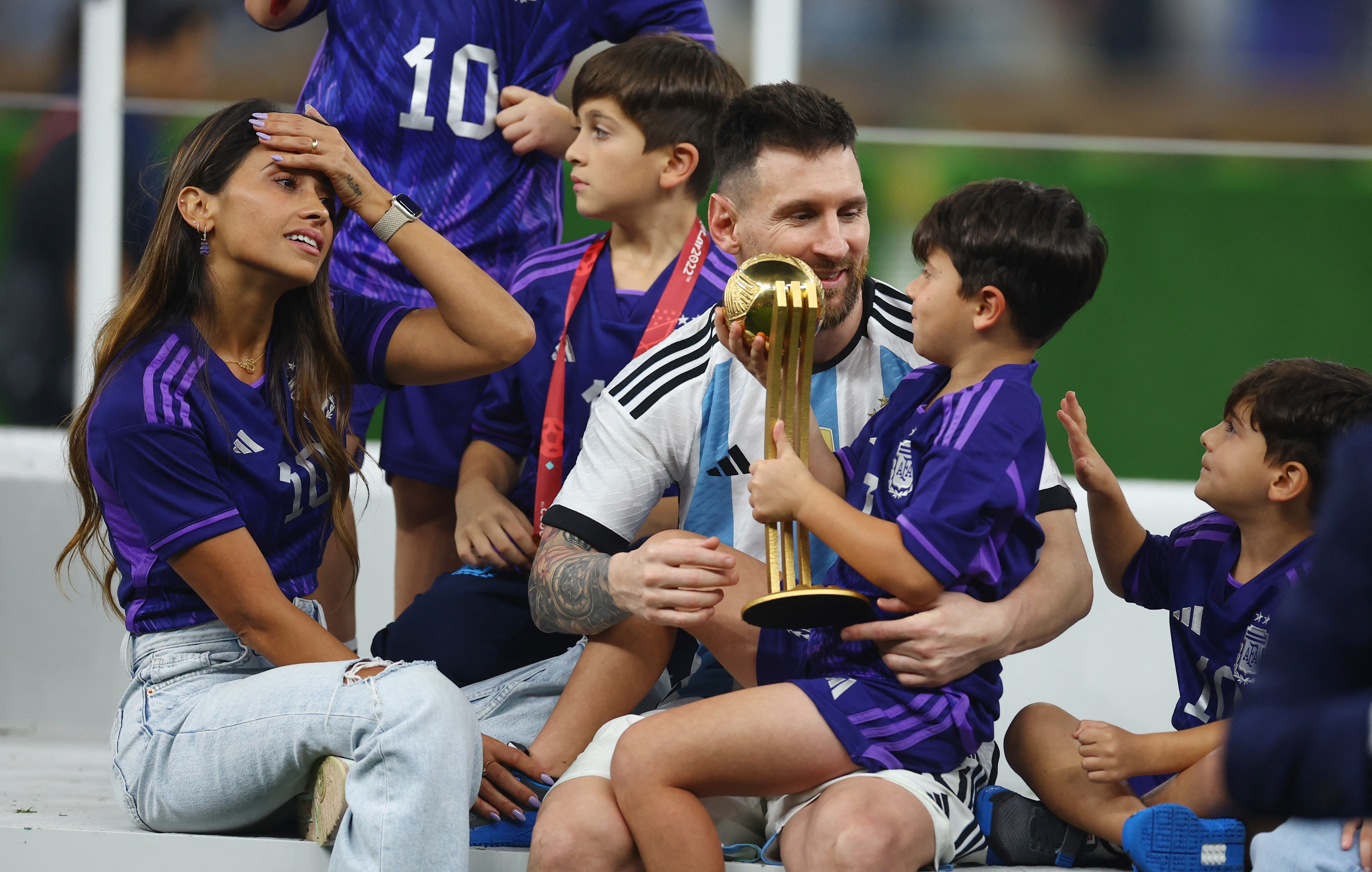 Soccer Football - FIFA World Cup Qatar 2022 - Final - Argentina v France - Lusail Stadium, Lusail, Qatar - December 18, 2022 Argentina's Lionel Messi celebrates with his wife, Antonela Roccuzzo, and their children after winning the World Cup REUTERS/Kai Pfaffenbach