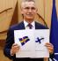 NATO Secretary General Jan Stoltemberg shows with satisfaction the flags of Sweden and Finland, which applied to join the military alliance after the Russian invasion of Ukraine